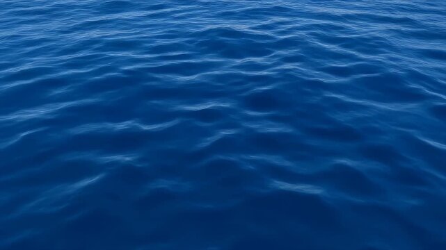 Close-up view of deep blue, subtly rippling ocean water surface texture.