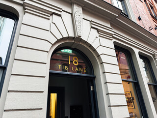 Naklejka premium Historic arched doorway at 18 Tib Lane in Manchester, UK, a classic building detail