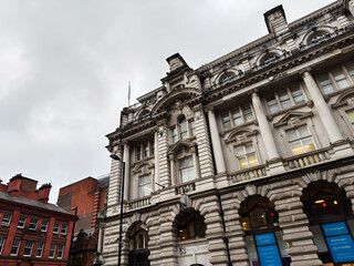 Naklejka premium Historic stone building on King Street Manchester with arches, columns, and ornate facade