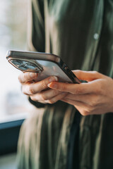 Close-Up of Woman Using Smartphone Indoors