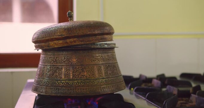 Close-Up of Traditional Uzbek Ornamental Teapot Heating on Open Flame