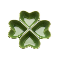 A green ceramic dish with four heart-shaped compartments on transparent background