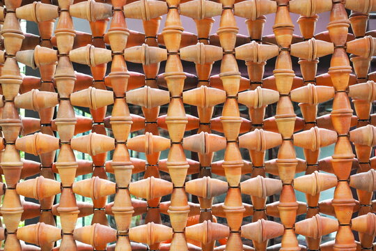 Terracotta wall decor made from terracotta pots, pattern background