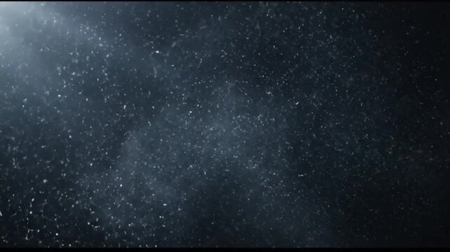 Dark cinematic lens particle loop, slow drifting specks with volumetric light