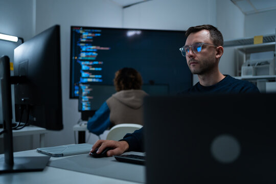 Focused professional software engineer working on laptop and agentic terminal coding in a modern office. Concept of SaaS, agentic workflow, enterprise software development, and reinventing tech.