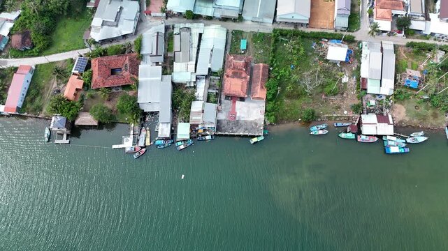 Cua Can, Phu Quoc Island, An Giang (Kien Giang) Province, Southern Vietnam &ndash; 4K aerial drone footage of polluted river with trash, coastal houses, fishing boats and village in Gulf of Thailand