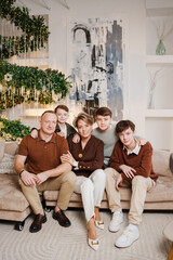 Family gathers around sofa during holiday season in cozy living room