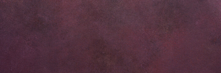 Fototapeta premium A dark maroon surface exhibits a subtle texture. Light and dark variations create a smooth, blended effect over the entire area, banner