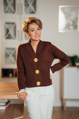 Woman standing by a table in a modern indoor space at daytime