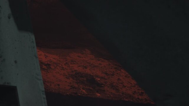 Glowing Sparks In Dark Factory. Intense Fiery Particles Cast Light Within Shadowed Factory Setting . Stock clip