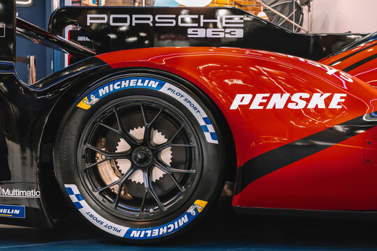 Rear wheel detail of Porsche 963 prototype with Michelin Pilot Sport tire and carbon fiber bodywork.