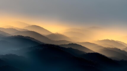 Obraz premium Mountain Whispers: A serene landscape reveals a sequence of mountain ridges enveloped in a misty veil. Sunlight casts a golden glow, painting a scene of tranquility and timeless beauty.