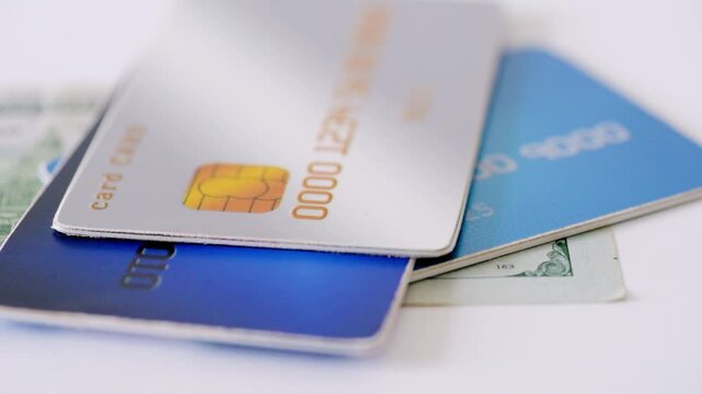 Money comparison tension. Cash versus card comparison. Financial debate between cash and credit cards. Juxtaposition of cash and credit cards highlighting spending choices