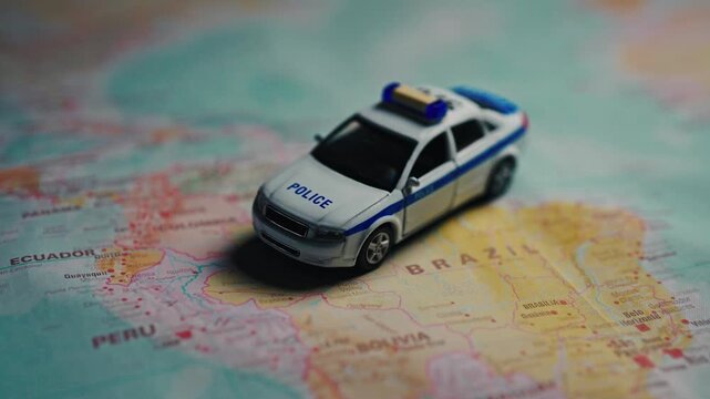 Police car model on South America map.
