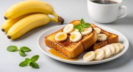 Delicious Golden Brown French Toast with Sliced Bananas, Fresh Mint, and a Hot Cup of Coffee