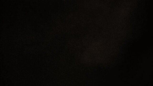 Dark abstract background with subtle brown and red hues, creating a mysterious atmosphere.