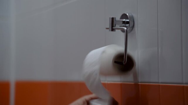 Unwinding toilet paper until the roll is empty