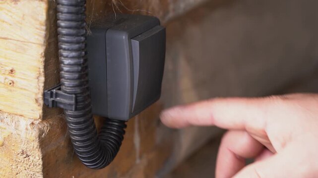 Pressing a finger on an electrical switch turns it on and off