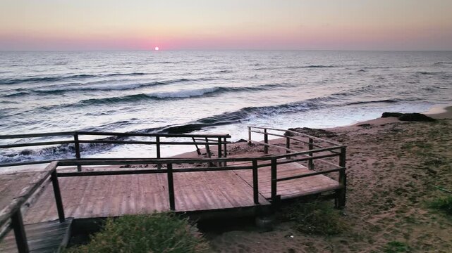 Ancient Stairs on Long Beach at Sunrise: Waves Kissing the Sand with Early Morning Light in Iskele
