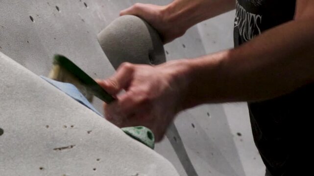 Video of a person preparing a boulder wall to go bouldering.