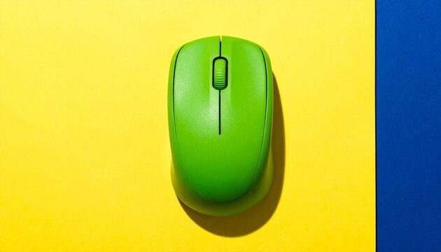 Bright green computer mouse on yellow surface with vertical blue strip.