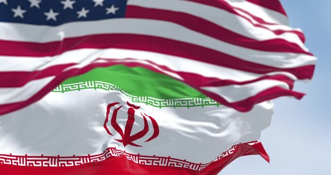 USA and Iran flags waving together.