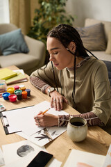 Creative moments in a modern apartment by a stylish young woman with braided hair © Bliss