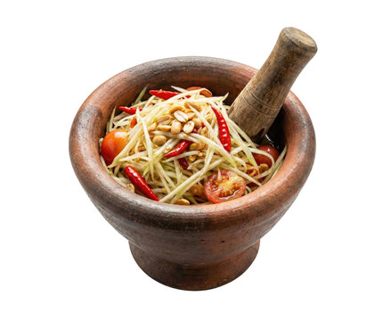 Green papaya salad in clay mortar isolated. Authentic Thai spicy food concept.