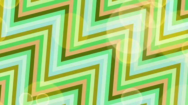 A vibrant zigzag pattern illustration featuring green, blue, and yellow stripes from a direct viewpoint