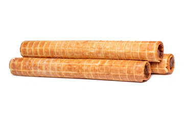 Crispy waffle tubes with sweet filling isolated on white background