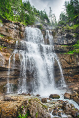 Obraz premium Water cascading down Vallesinella Falls in the Dolomites, Italy