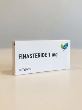 Medicine box of finasteride. White box with some small graphic design, neutral background. bright, professional photo