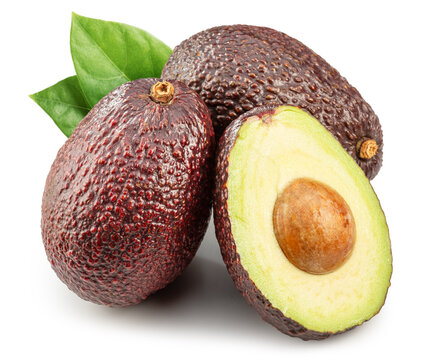 Hass avocado fruits and halved avocado with leaves isolated on white background.