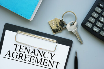 Tenancy agreement document for rental property, lease contract signing concept, real estate paperwork, renting home or apartment, landlord and tenant legal agreement