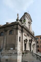 Fototapeta premium Historic building facade with ornate architectural details and cross