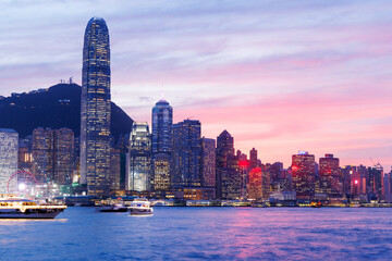 Hong Kong city skyline at sunset with glowing sky and skyscrapers