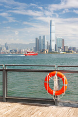 Hong Kong skyscraper panorama on a sunny day with water and boats