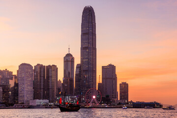 Hong Kong city skyline at sunset with glowing sky and skyscrapers