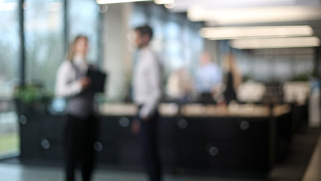 A blurry image of a group of people in a room