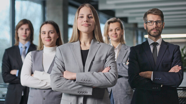 A group of people in business attire are posing for a photo