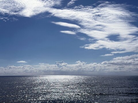 Beautiful clouds in the sky over glittering sea.