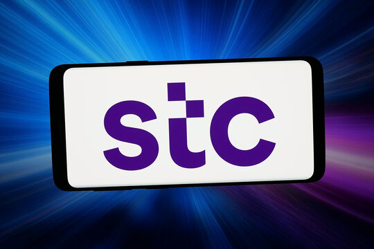 Stuttgart, Germany - 02-25-2026: In this photo illustration, the logo of business Saudi Telecom Company (STC) is displayed on a smartphone in front of abstract background on computer screen.