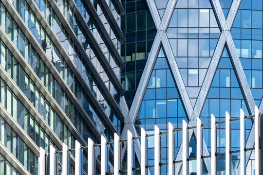 Blue glass facade on modern corporate building with urban architecture pattern and structure showing contemporary office district exterior and clean city business look