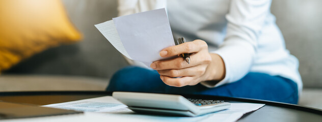 Women business people use calculators to calculate the company budget and income reports on the...