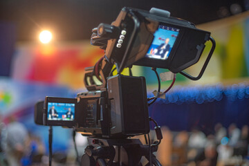 Professional Broadcast Video Camera Monitoring Live Event with Two Screens and Copy Space