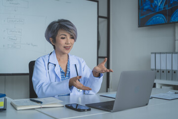 Senior Female Doctor Explaining Treatment Plan During Video Call