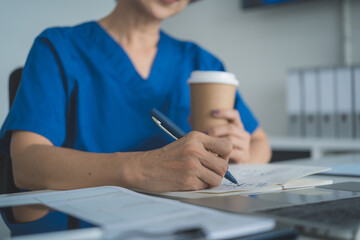Female Doctor Taking Notes in Medical Notebook During Workday