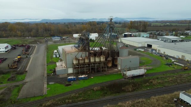 US, OR, Harrisburg, , 2025-11-23 - Drone view of a chemical processing plant with old dirty pipes leading to a tower at CHS Nutrition, in fall