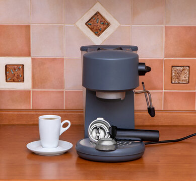 Coffee machine, cup of espresso on table. Coffee Maker in the kitchen interior.