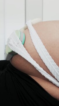 Pregnant woman undergoing cardiotocography fetal monitoring